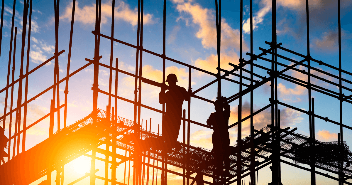 Construction company workers on a metal building