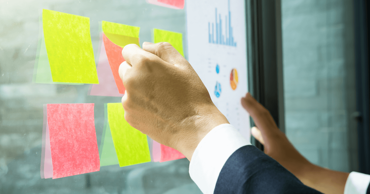 A man brainstorming marketing solutions with paper sticky notes