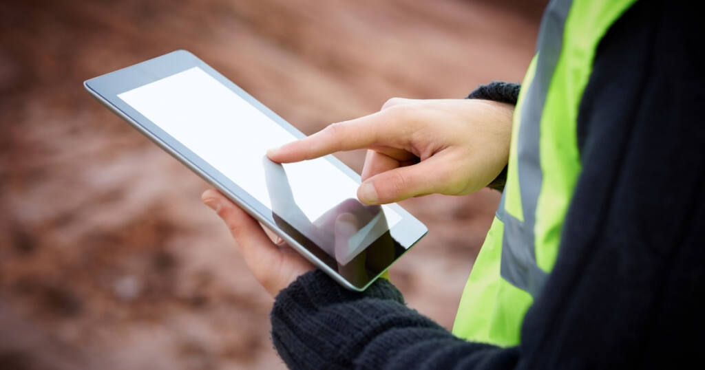 Construction company manager reviewing Google Ads services on tablet