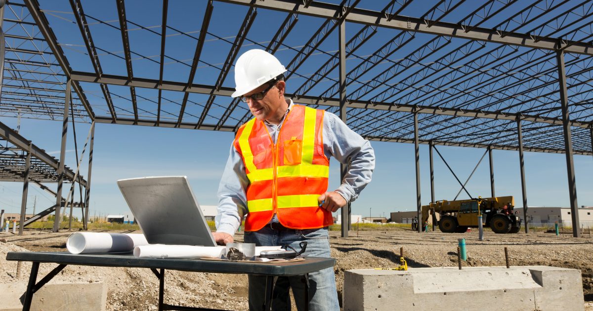 A project manager reviewing lead generation for construction companies on a job site