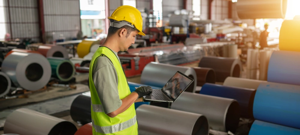 Lead manufacturer reviewing manufacturing company marketing on a laptop