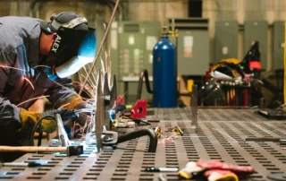 Manufacturing warehouse worker helping produce services and goods to create marketing strategy for manufacturers