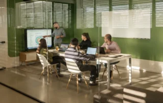 Quarterly meeting in green conference room for B2B digital marketing agency