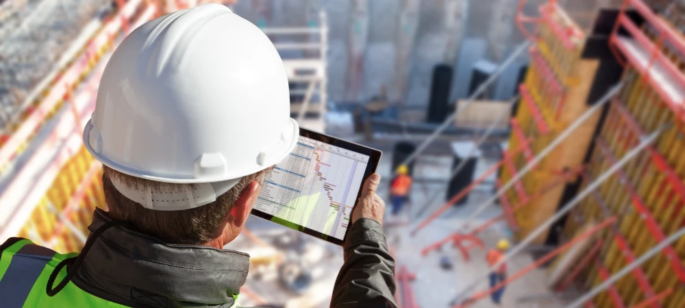 commercial-construction-marketing-strategy-data-review Commercial construction marketing company project manager reviewing dashboards for project statuses