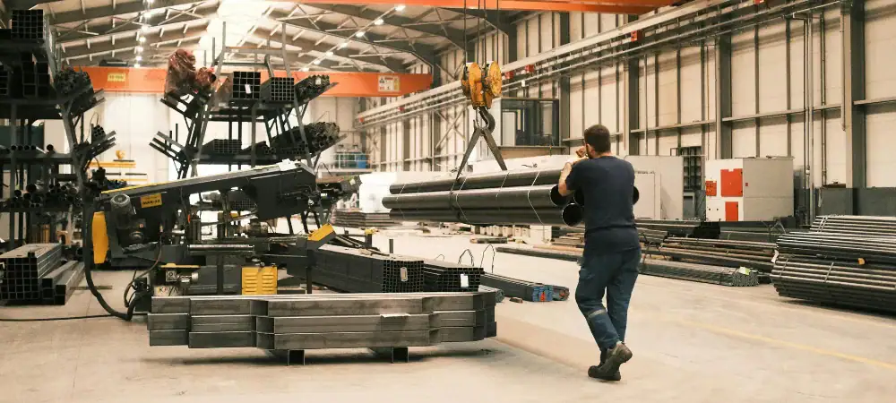 Worker operating industrial machinery in a manufacturing marketing facility.